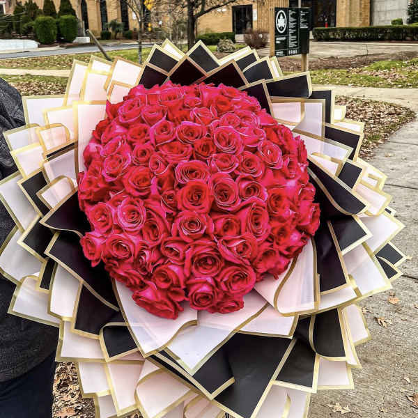 Large bouquet of hot pink roses with black and white wrapping