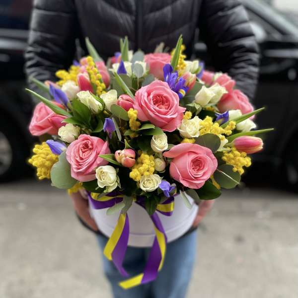 Pink and white rose bouquet with purple accents in a white hat box
