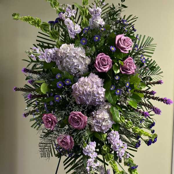Tall standing floral spray with pink roses and lavender blooms