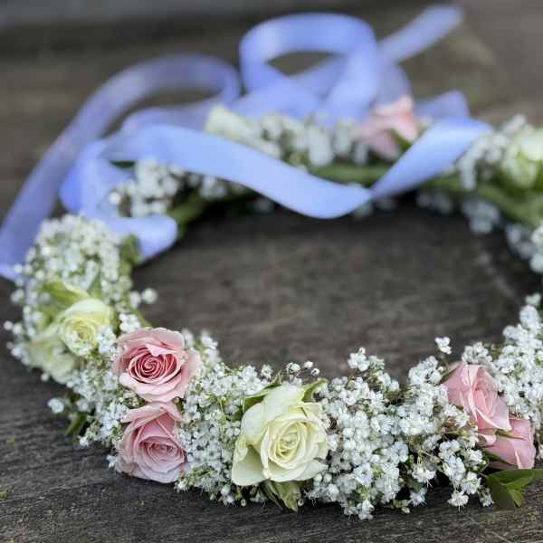 Floral crown of pink and white roses with a lavender ribbon