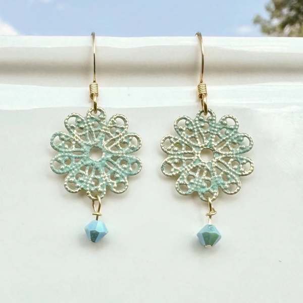 Pair of dangling floral earrings with blue beads