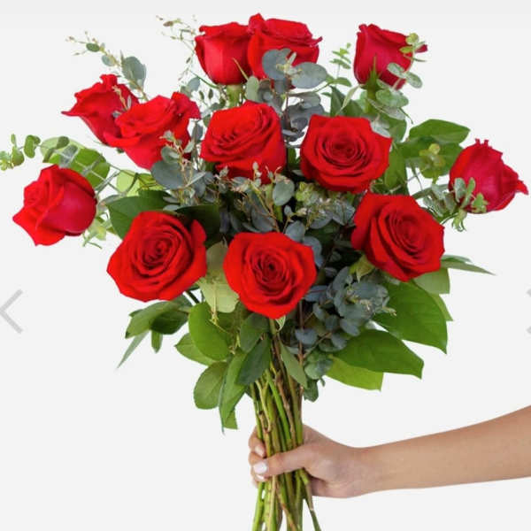 Handheld bouquet of red roses with eucalyptus greenery