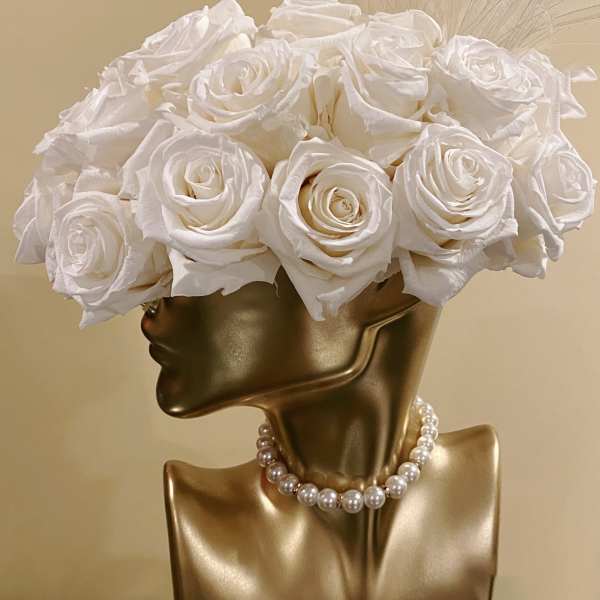 White rose bouquet on a gold mannequin bust with a pearl necklace