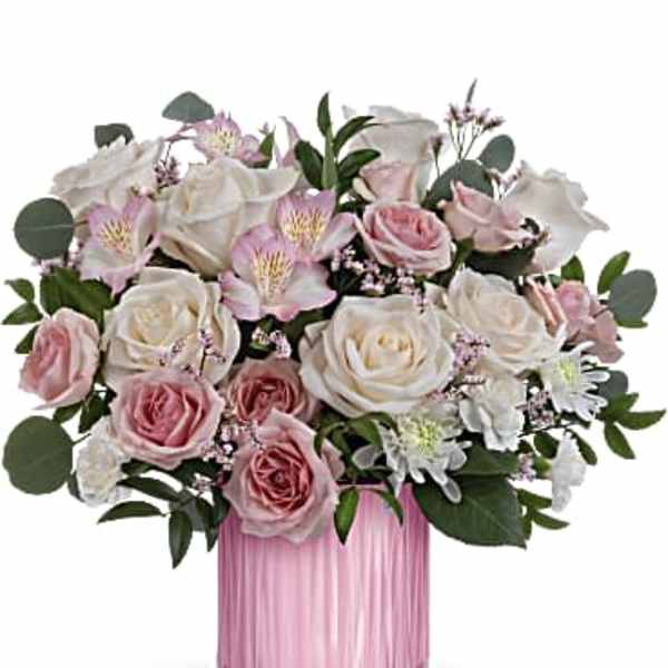 Pink and white roses in a pink glass vase