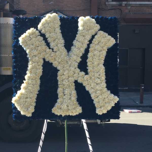 White floral monogram on a dark blue display board