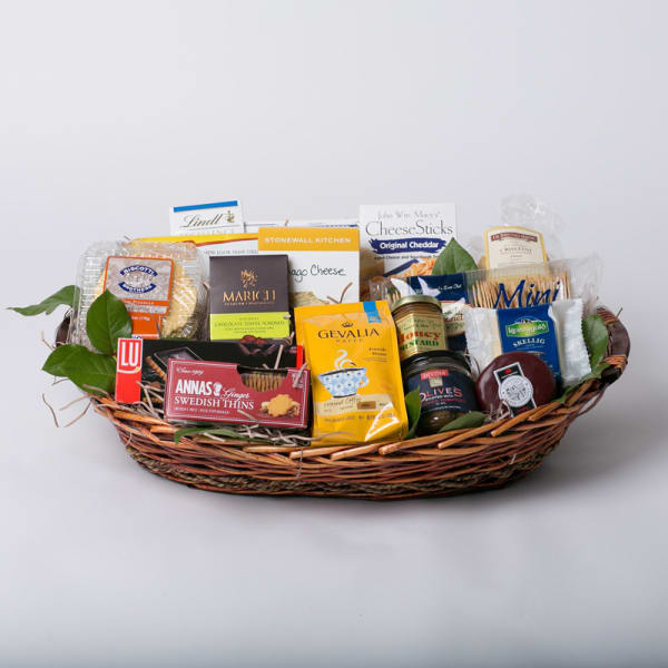Gift basket with assorted packaged snacks and chocolates in a wicker tray