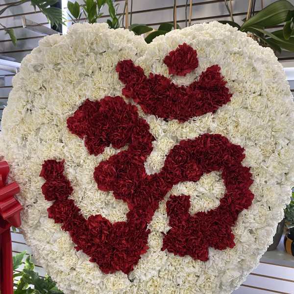 Heart-shaped white and red carnation funeral spray