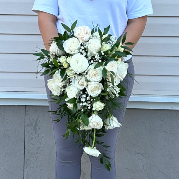 White rose bridal bouquet with trailing greenery and baby's breath