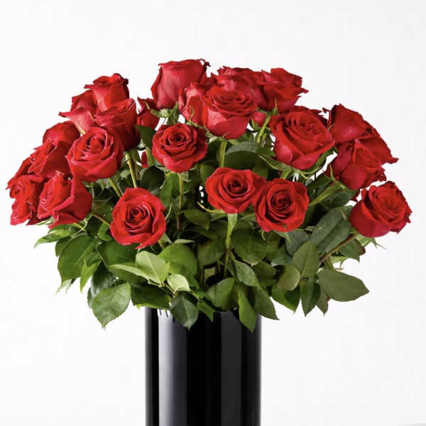 Red roses arranged in a tall black vase
