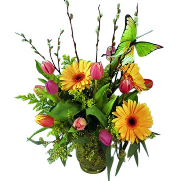 Bright mixed bouquet with yellow gerbera daisies and pink tulips in a glass vase