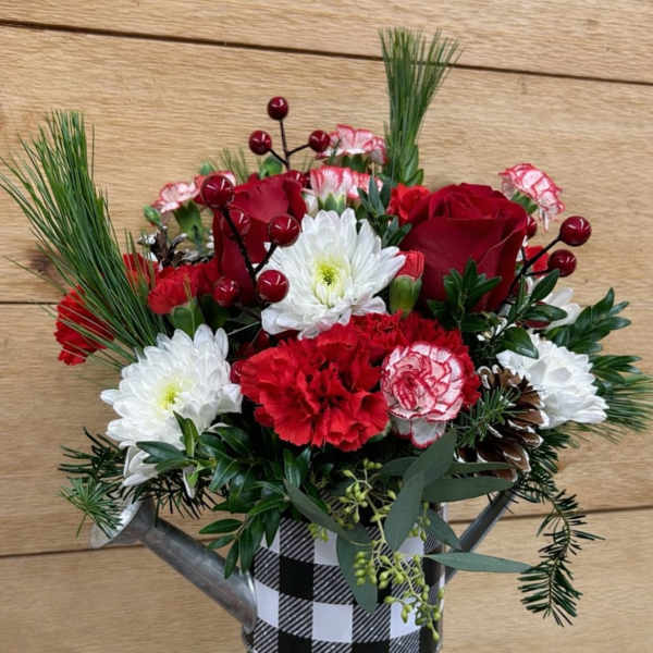 Red and white floral arrangement in a checkered metal container