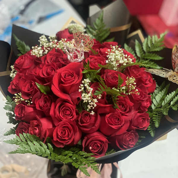Bouquet of red roses with baby's breath and fern accents