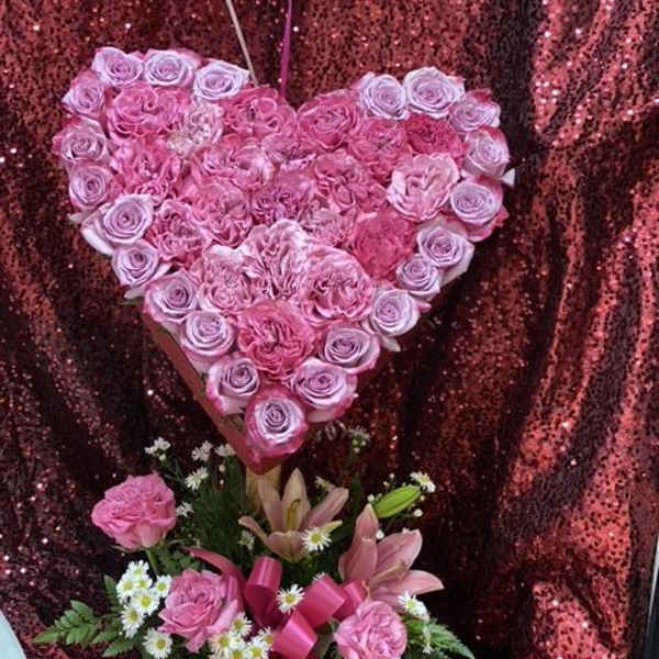 Heart-shaped pink rose arrangement with a smaller mixed bouquet below