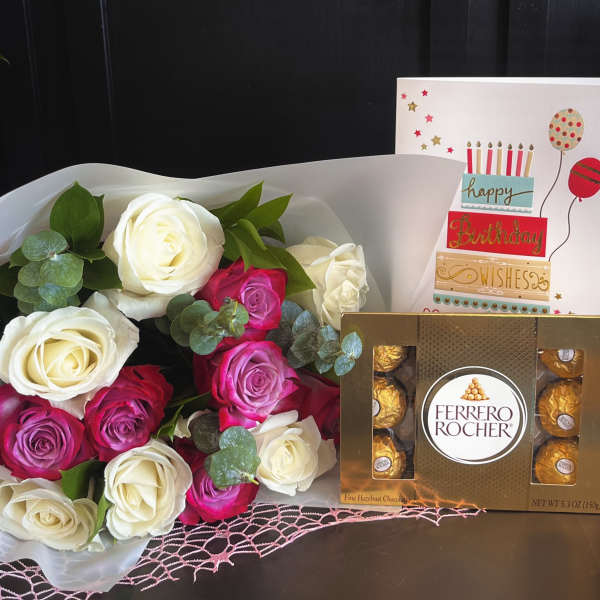 Bouquet of white and pink roses with a birthday card and Ferrero Rocher chocolates