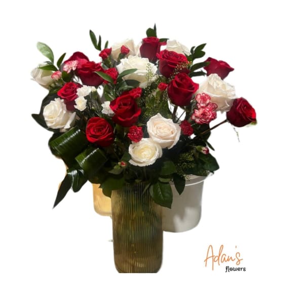 Bouquet of red and white roses in a tall ribbed vase