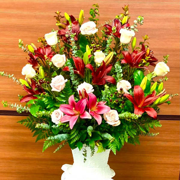 Large bouquet of lilies and roses in a white vase