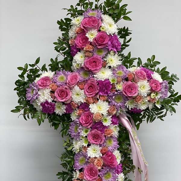 Cross-shaped floral spray with pink roses and white daisies