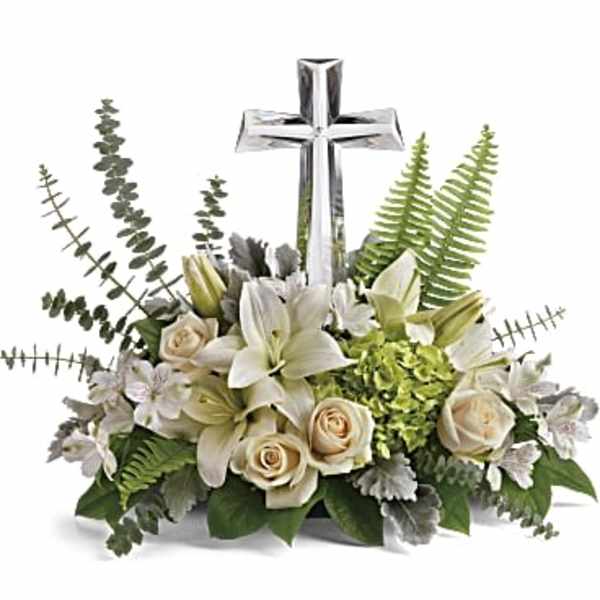 White floral arrangement with a silver cross centerpiece