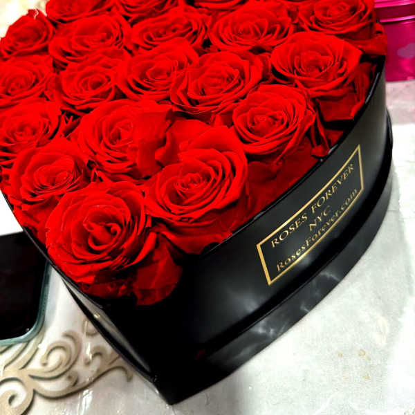 Heart-shaped box of red roses with a pink "Sweet On" lid