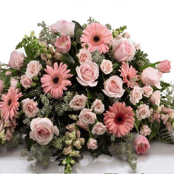 Pink rose and gerbera daisy casket spray with soft filler flowers