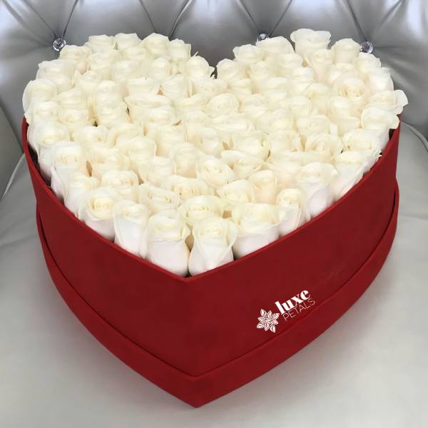 Heart-shaped box filled with white roses