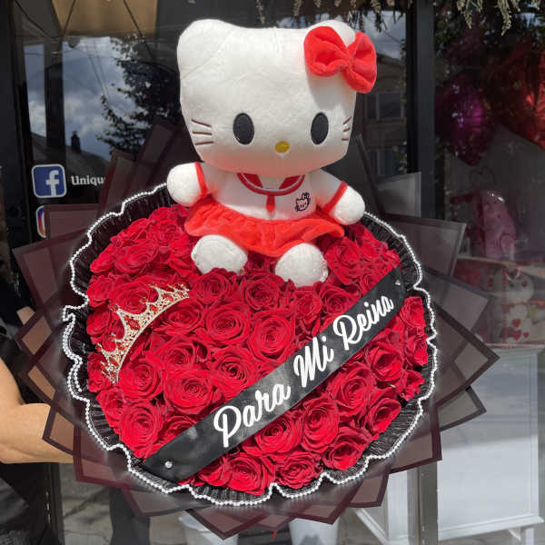 Hello Kitty plush sitting in a heart-shaped red rose bouquet