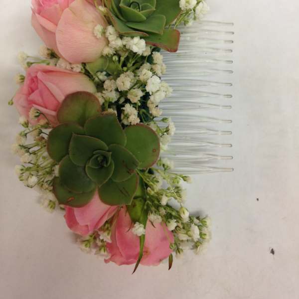 Pink rose hair comb with green succulents and white filler flowers