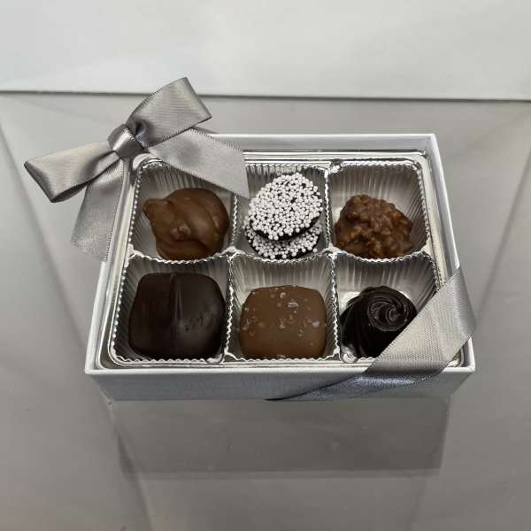 Box of assorted chocolates with a silver ribbon bow
