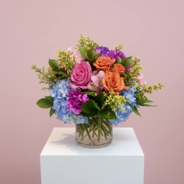 Colorful bouquet of roses and hydrangeas in a glass vase
