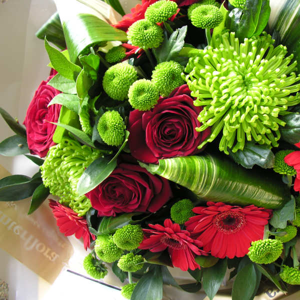 Bouquet of red roses, red gerbera daisies, and green chrysanthemums