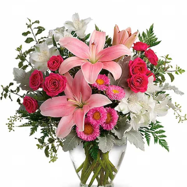 Pink lilies and roses arranged in a clear glass vase
