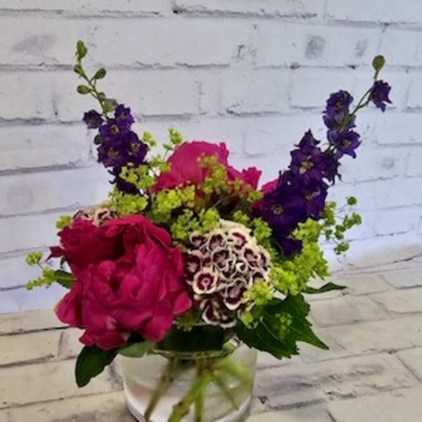 Pink and purple mixed bouquet in a clear glass vase