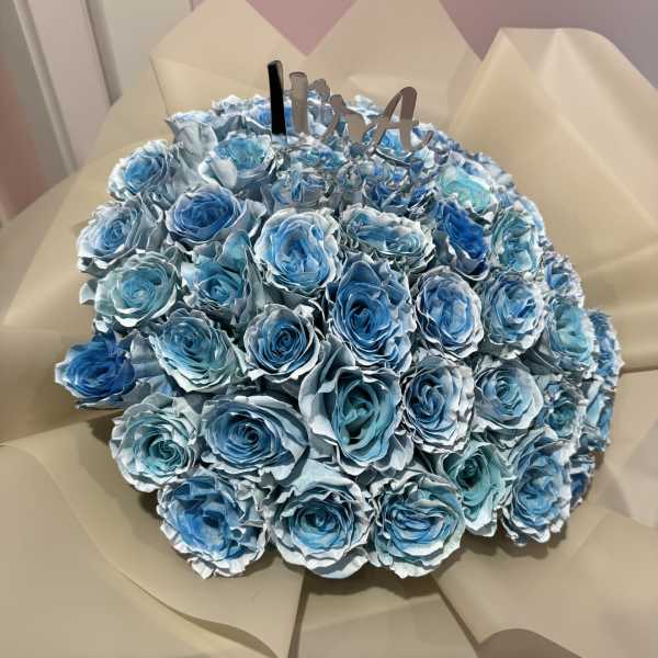 Bouquet of blue roses wrapped in beige paper
