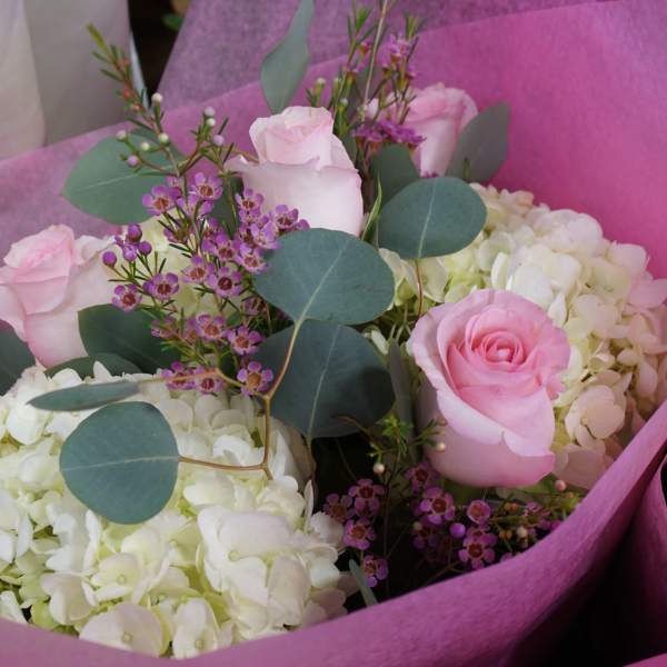 Pink roses and white hydrangeas in pink wrapping