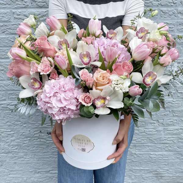 Large pink and white flower arrangement in a white hat box