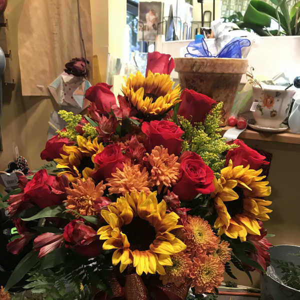 Bouquet of red roses and sunflowers with orange mums