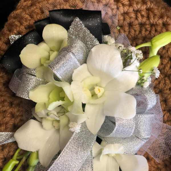 White orchid bouquet with silver ribbon and black wrap