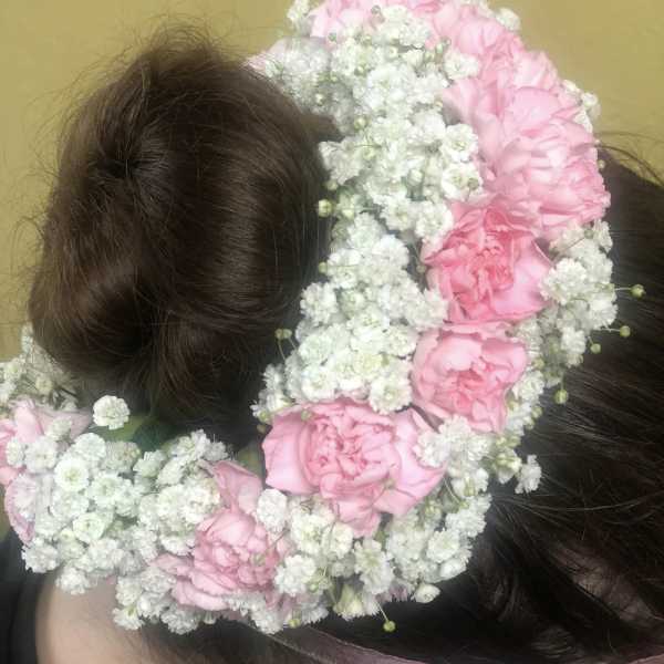 Pink flower crown on a person's head