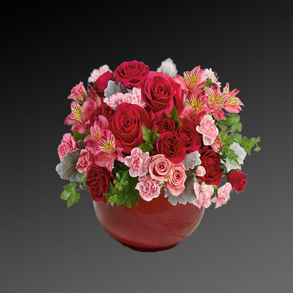 Pink and red rose bouquet in a red vase