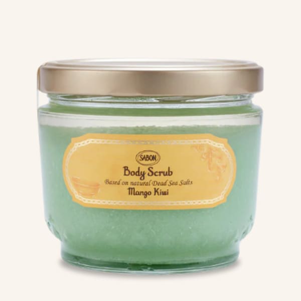 Jar of green body scrub with a gold lid