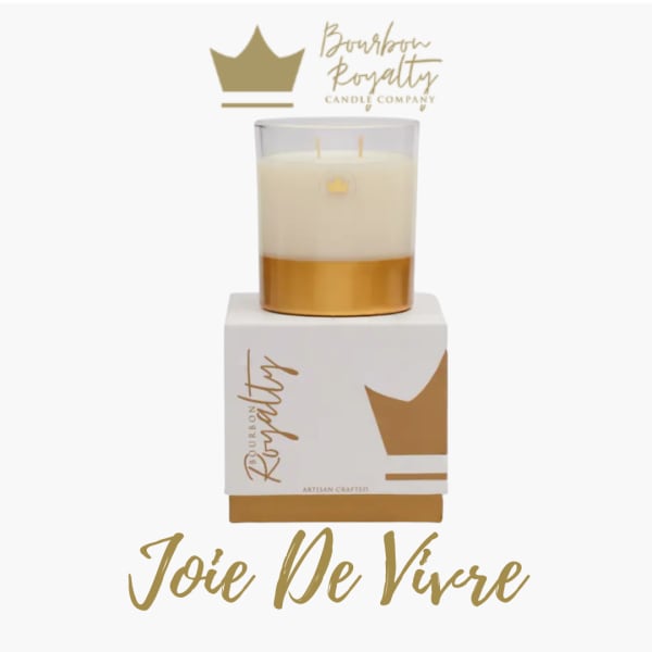Gold and white candle in a branded box