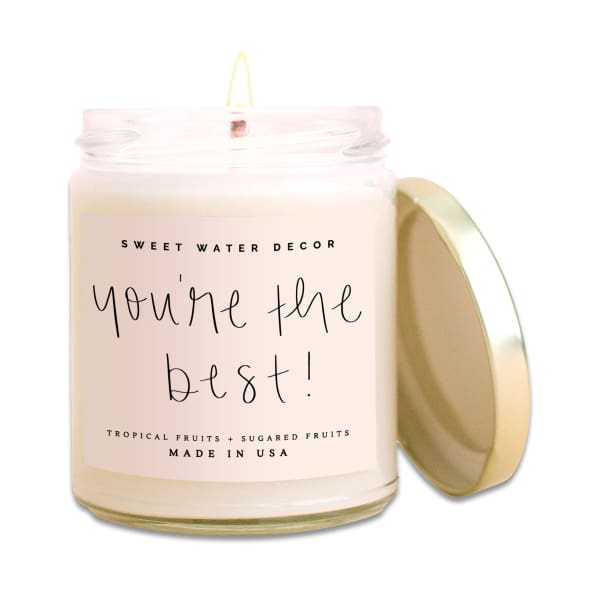 Labeled candle in a glass jar with a gold lid