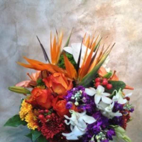 Colorful tropical bouquet with orange roses and white orchids