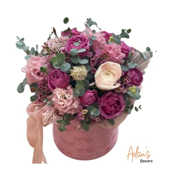Pink and white bouquet in a round pink box with ribbon