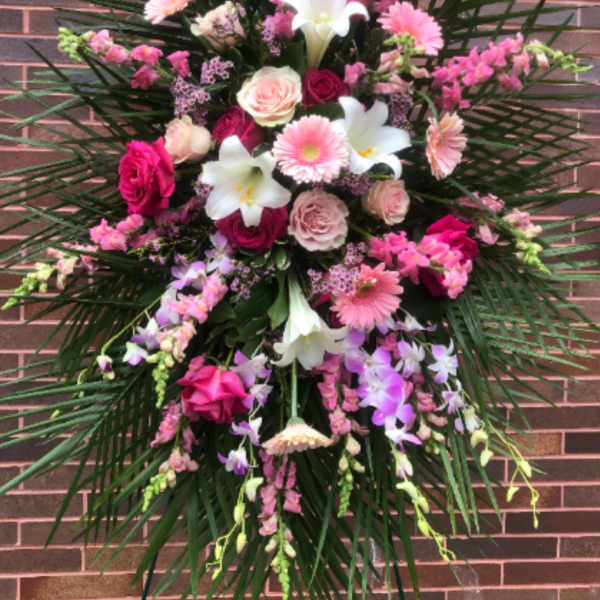 Large pink and white floral standing spray with lilies and roses