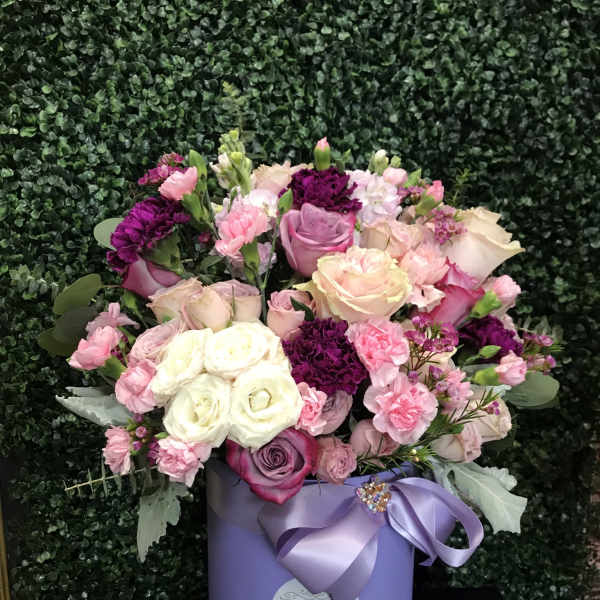 Pink and white rose bouquet in a lavender hat box with ribbon