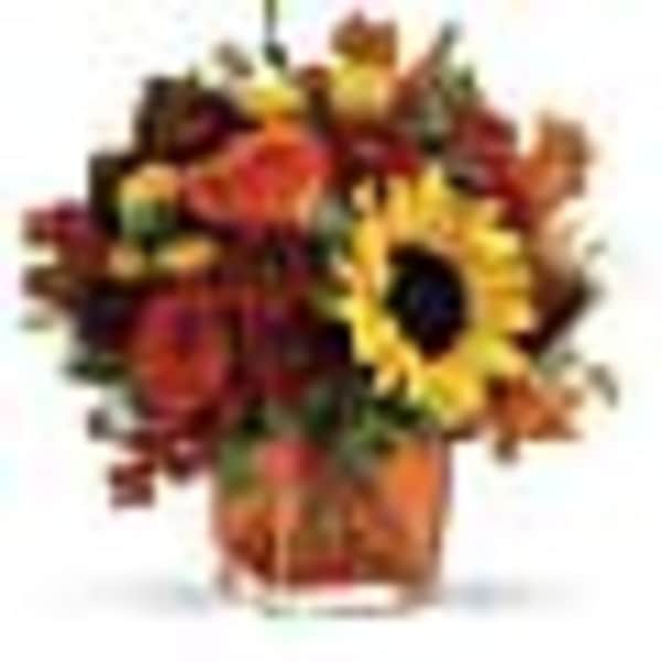 Mixed bouquet with a sunflower and red-orange flowers in a vase