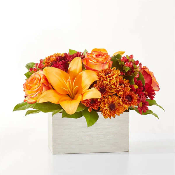Orange lilies and roses in a white rectangular box