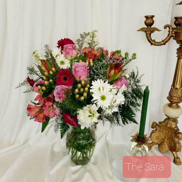 Mixed pink and white flower arrangement in a glass vase
