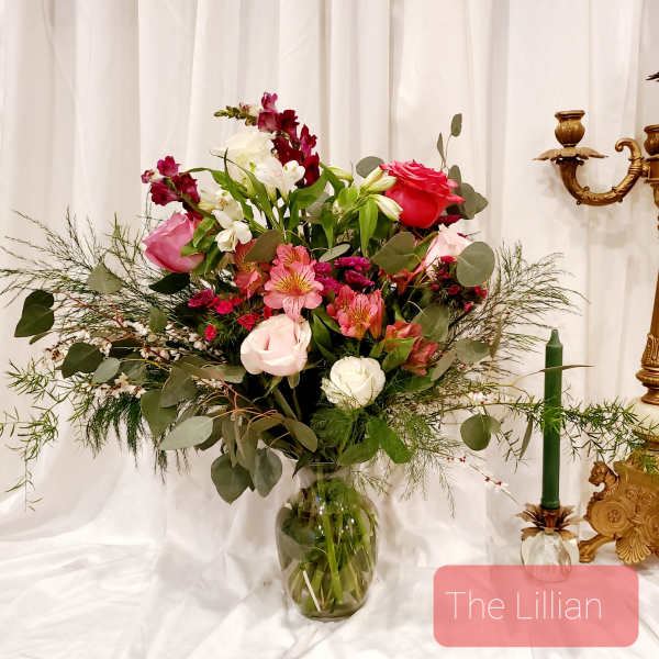 Mixed pink and white flower arrangement in a glass vase